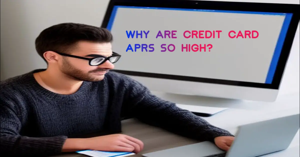 A Man sitting at a desk using a laptop computer, Thinking about Why are credit card APRs so high