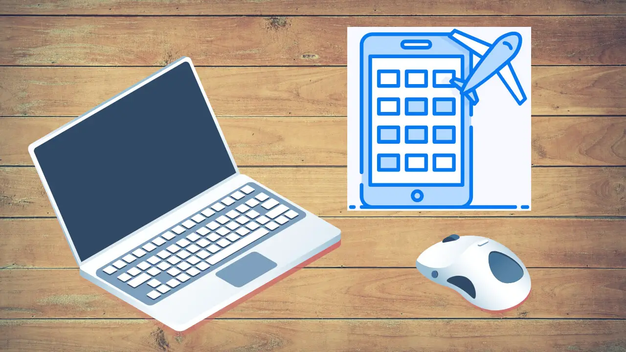 a laptop computer sitting on top of a wooden table next to a mouse and a paper with a drawing of a plane. Earn Points For Booking Ita Airways Flights